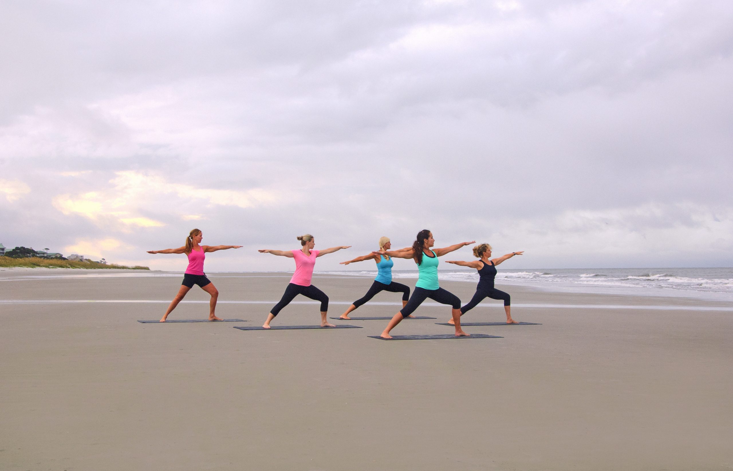 Hilton Head Health Retreat practicing yoga on the beach to help extinguish burnout