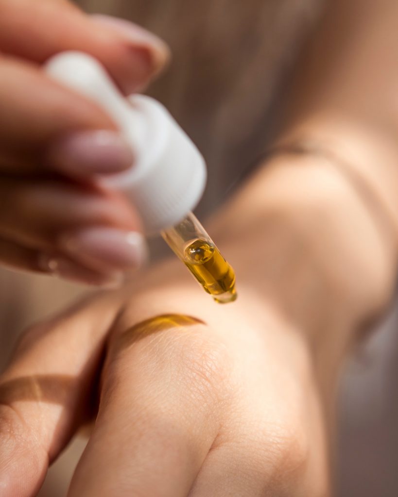 woman putting cbd on her wrist for pain relief