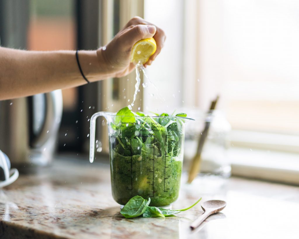 squeezing lemon into smoothie - plant-based diet