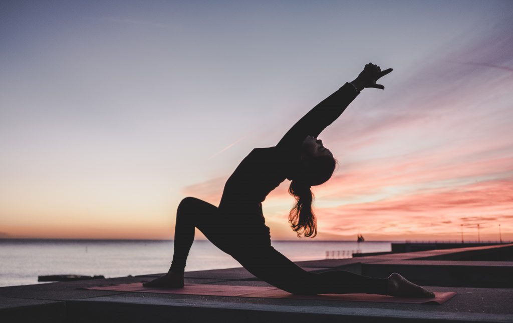 woman doing yoga pose - are yoga retreats worth it - unsplash