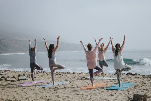 yoga on the beach - are yoga retreats worth it - unsplash