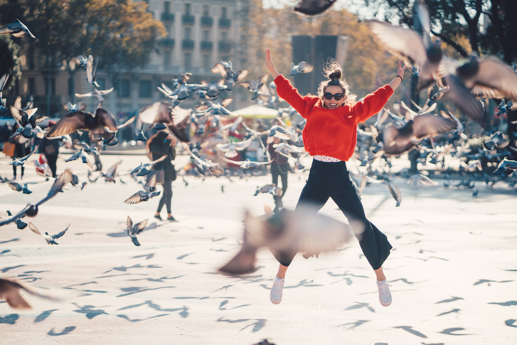 Girl jumping for joy at Placa de Catalunya