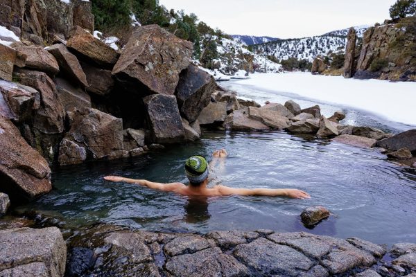 man relaxing in hot springs in colorado