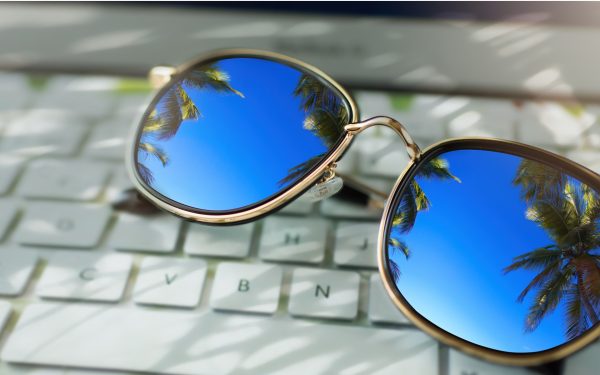 workation dream sunglasses on laptop keyboard